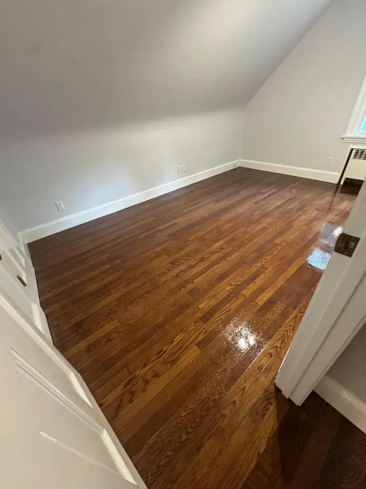 Stained hardwood floor in bedroom