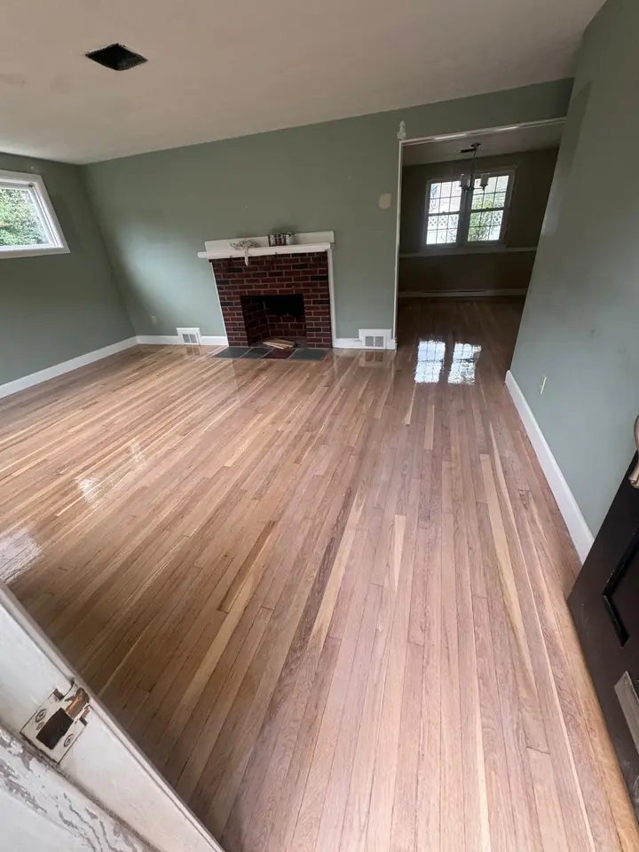 Living room with fireplace and refinished floor