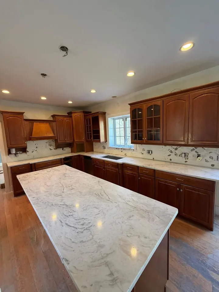 Kitchen with hardwood floor and marble island