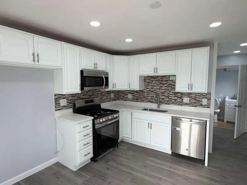 Kitchen with gray vinyl plank flooring installed by WD Art